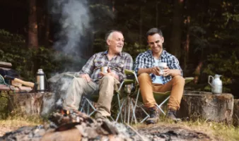 Father and son at a campfire, which could create wildfire smoke