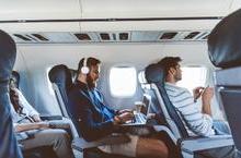 Travelers working and relaxing on a flight