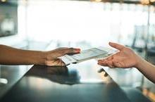 Person handing ticket to clerk