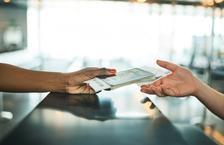 Person handing ticket to clerk