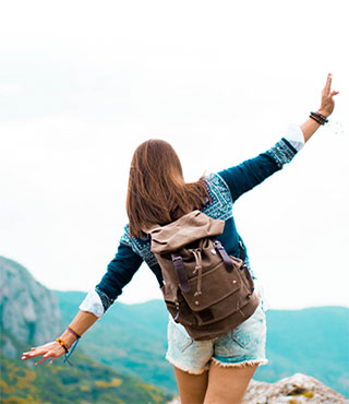 young woman walking in mountains