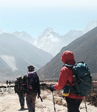 group of people hiking through mountains