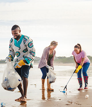 group of volunteers picking up trash