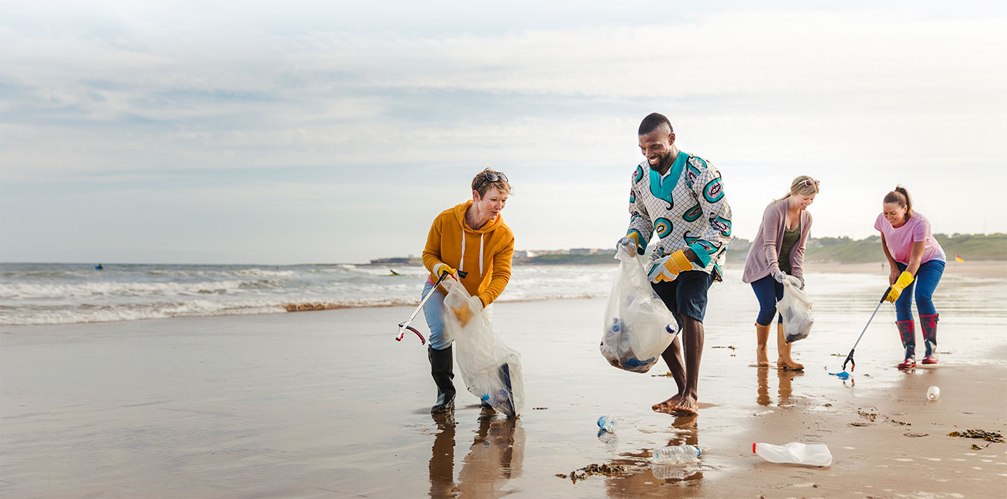 group of volunteers picking up trash