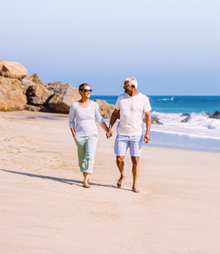 Senior couple walking on beach