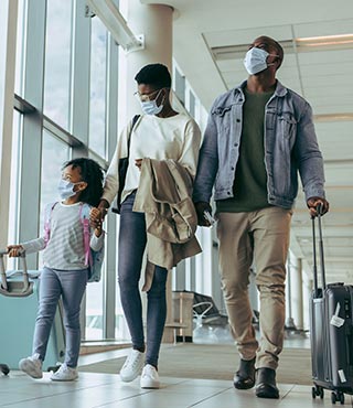 Family walking through airport passageway