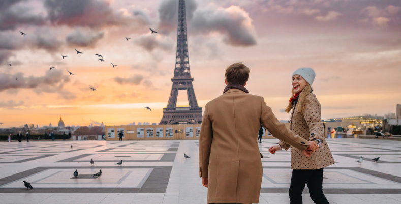 A couple enjoying a trip to Paris, France, one of the most romantic places in the world.