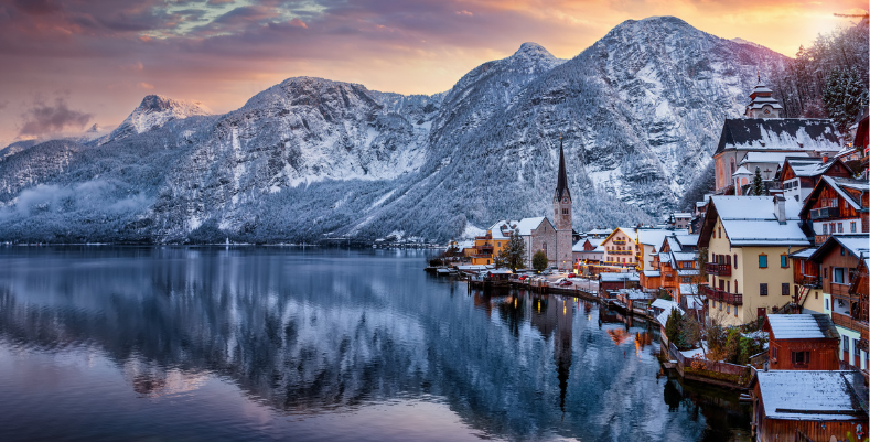 Read our Europe travel guide before you see views like this one of Hallstatt, Austria with water and mountains.