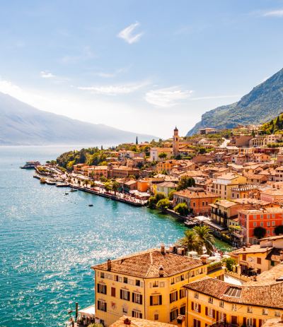 Travel insurance for Italy trips can help protect your vacation to see this view of Limone Sul Garda city and Garda lake.