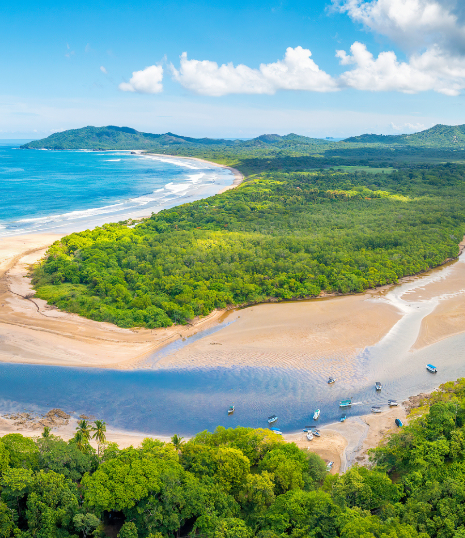 Aerial view of beach, ocean, and foliage for travel insurance for Costa Rica page