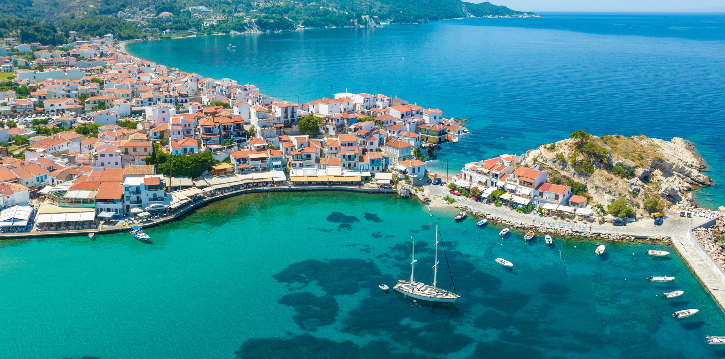 Aerial view of ocean and Kokkari village on Samos Island, where you can travel with travel insurance for Greece