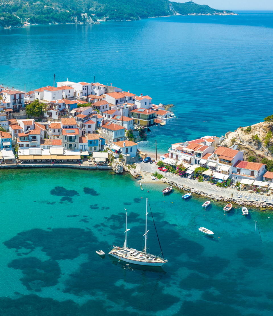 Aerial view of ocean and Kokkari village on Samos Island, where you can travel with travel insurance for Greece