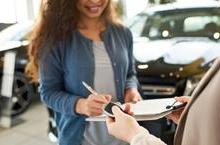 Woman signing rental agreement