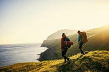 Backpackers climbing down a hill