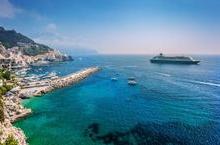 Cruise ship pulling up to a beautiful island