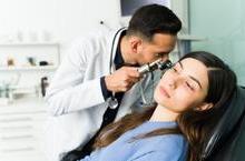 Doctor examining patient&#039;s ear