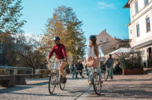 Couple touring as responsible travelers on bikes to reduce carbon emissions.