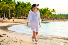 Woman walking on the beach during Caribbean travel.