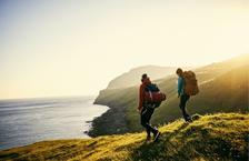 Backpackers climbing down a hill