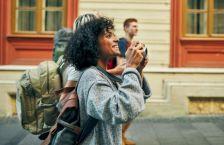 Female traveler holding camera 