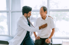 Doctor checking patient&#039;s heart at a travel health care appointment