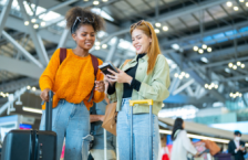 Two women in an airport, with one trying not to lose her passport.